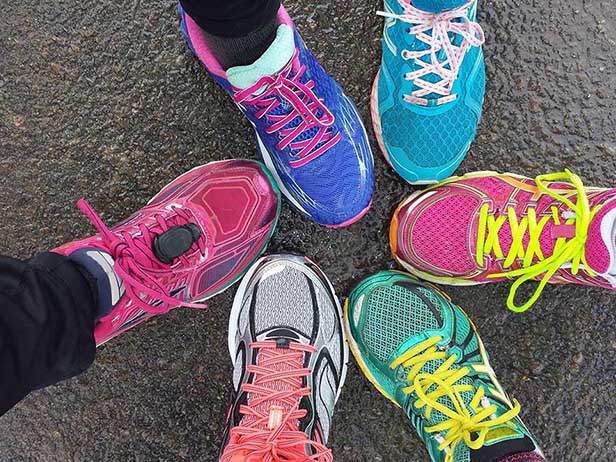 Six different coloured trainers all pointing inwards in a circle
