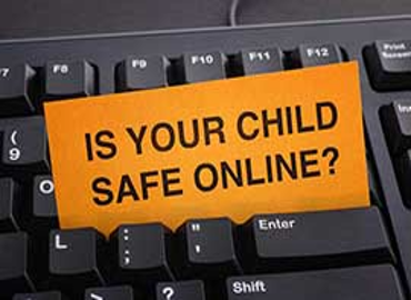 Keyboard with a card and the words is your child safe online?