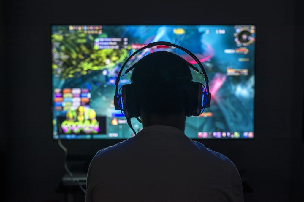 young gamer playing video games wearing headphones