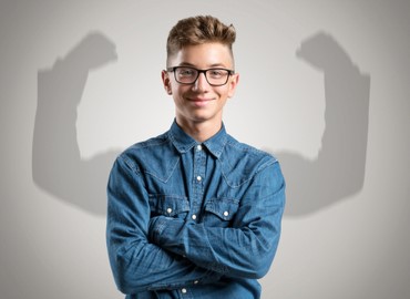 Young Boy With Shadow Holding Strong Confident Arms Behind Him