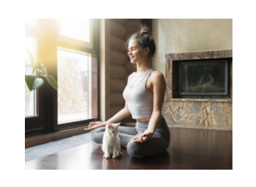 Girl in yoga pose with a cat